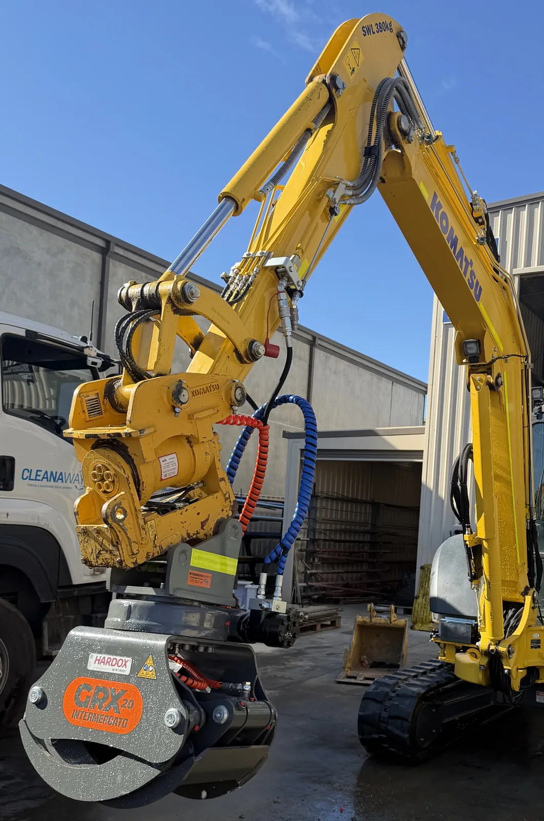Yellow excavator fitted with an attachment during an attachment repair in Canberra