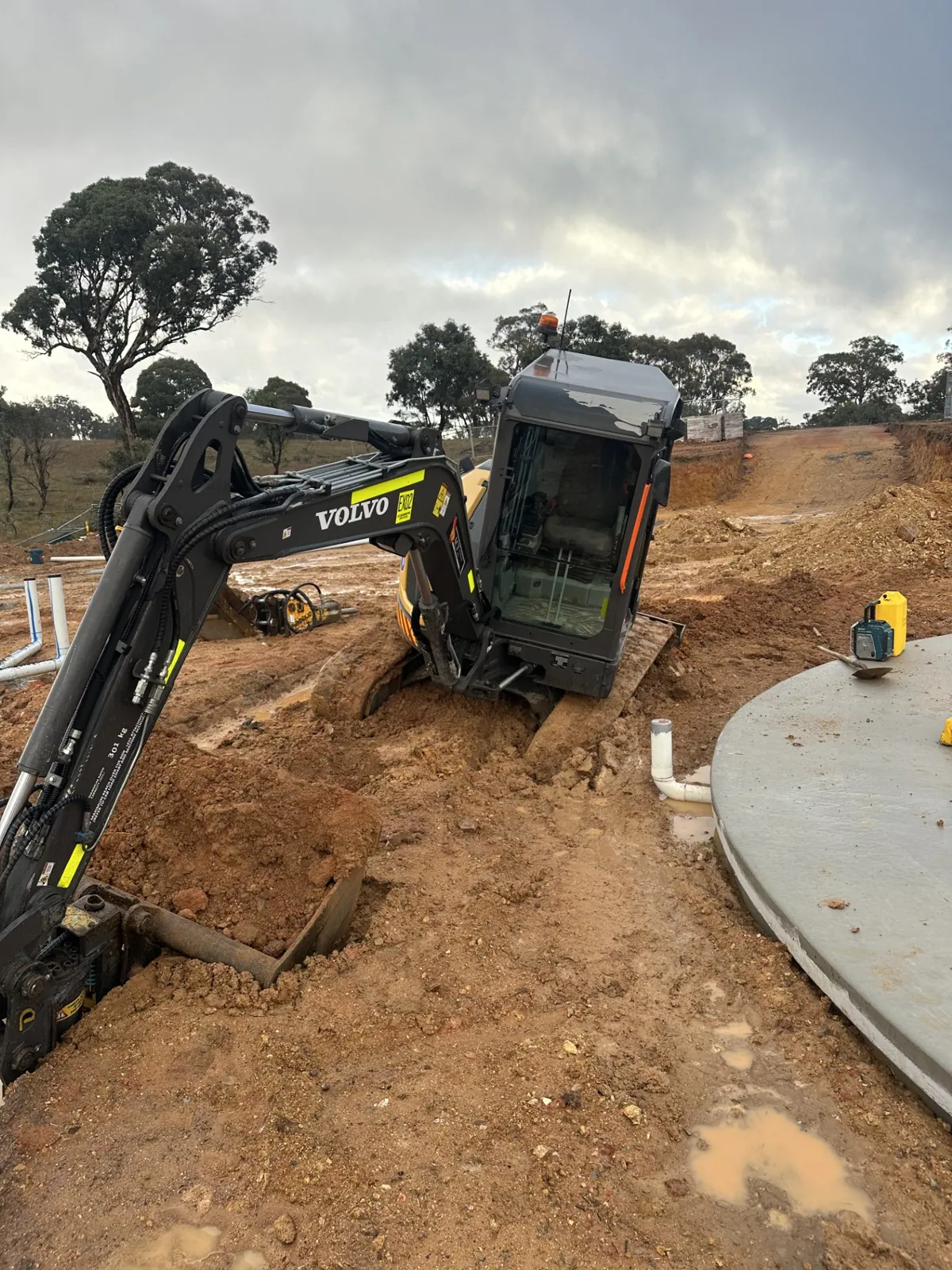 Volvo excavator working on a site cut after a hydraulic repair in the Canberra region